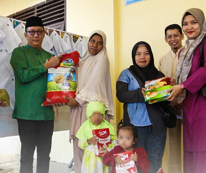 Plt Kepala BKPSDM Pekanbaru Fabillah Sandy saat menyalurkan makanan bergizi kepada dua balita di Kelurahan Pesisir, Jumat (5/5/2023). Foto: Istimewa.