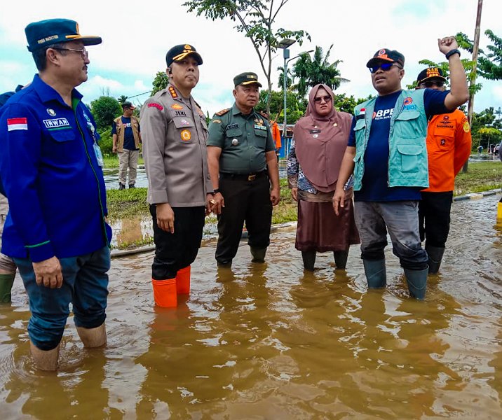 Kalaksa BPBD Pekanbaru Zarman Candra (kanan) bersama Kapolresta, Kodim, dan camat Rumbai meninjau banjir yang menggenangi Jalan Jenderal Sudirman di wilayah Meranti Pandak pada 11 Januari 2024. Foto: Istimewa.