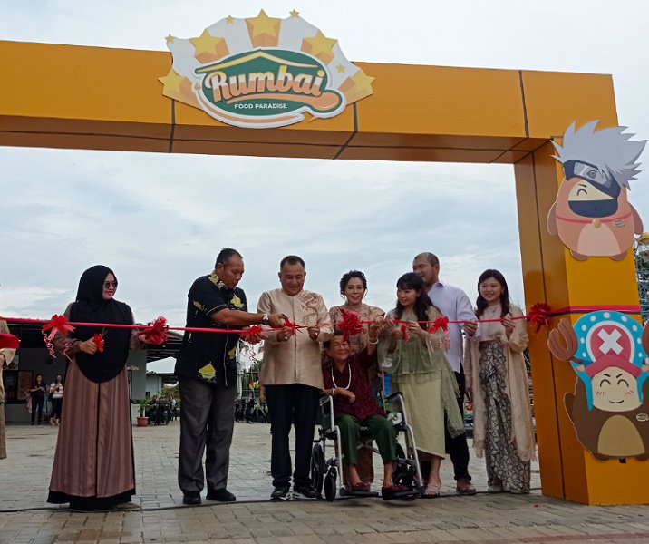 Asisten II Setdako Pekanbaru Ingot Ahmad Hutasuhut memotong pita bersama Direktur Rumbai Food Paradise Nata bersama keluarganya, Sabtu (20/4/2024). Foto: Surya/Riau1.