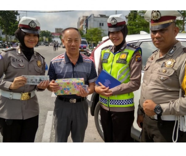 Pak Rahman saat mendapat hadiah dari Polantas yanf menggelar Operasi Zebra Muara Takus 2018, di Jalan Ahmad Yani Pekanbaru (Foto: Riandi)
