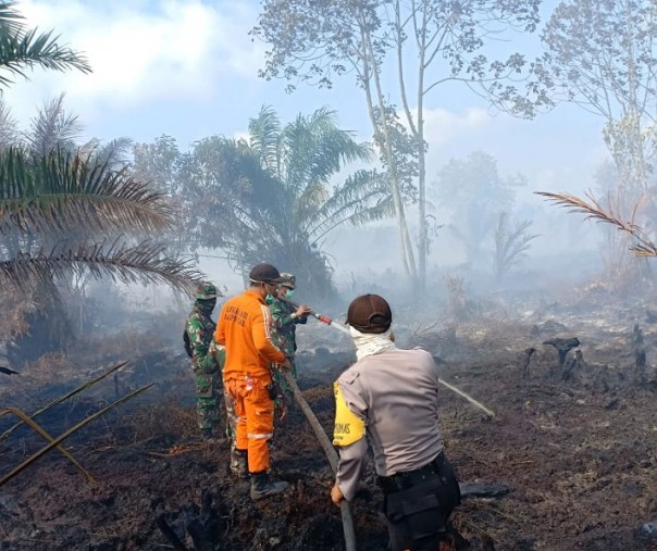 Satgas karhutla Riau sedang melakukan pendinginan pada lahan gambut yang tengah terbakar (Foto: Istimewa/ Manggala Agni Daops Pekanbaru)