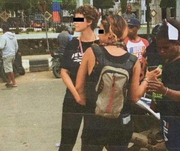 Dua dari empat warga negara Australia saat ikut dalam aksi Demo Papua Merdeka. Si wanita melihatkan sesuatu di ponselnya ke warga lokal. Foto: Liputan6.com.