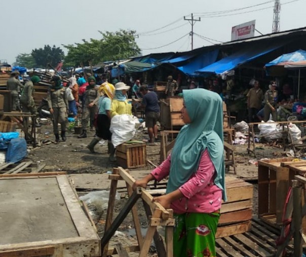 Petugas Satpol PP Pekanbaru saat mengawasi PKL yang membongkar sendiri lapak dagangannya di Pasar Pagi Arengka. Foto: Satpol PP Pekanbaru.