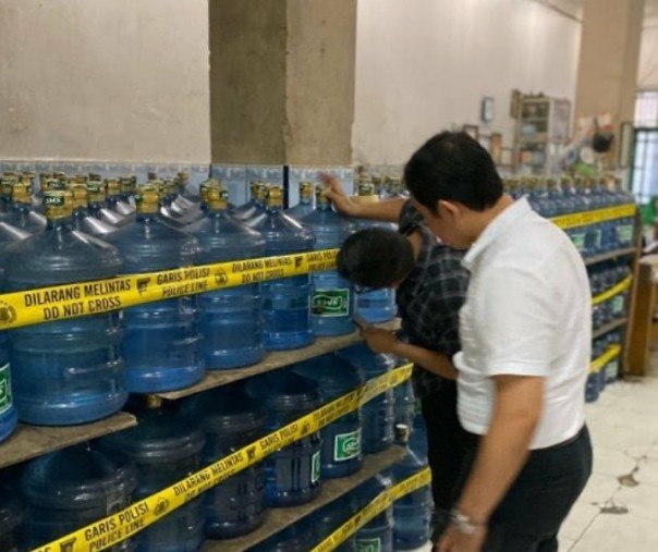 Pihak Polda Sumbar menyegel produk air mineral kemasan SMS. Foto: Antara.
