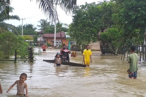 Tak Kunjung Dapat Bantuan, Warga Kampar Ini Nekat Arungi Banjir Untuk Membeli Makanan