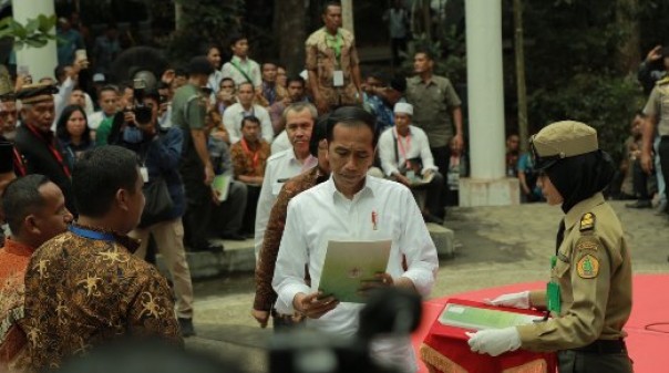 Presiden Jokowi saat menyerahkan secara simbolis SK Perhutanan Sosial dari Kementerian LHK untuk masyarakat Riau di Tahura Siak