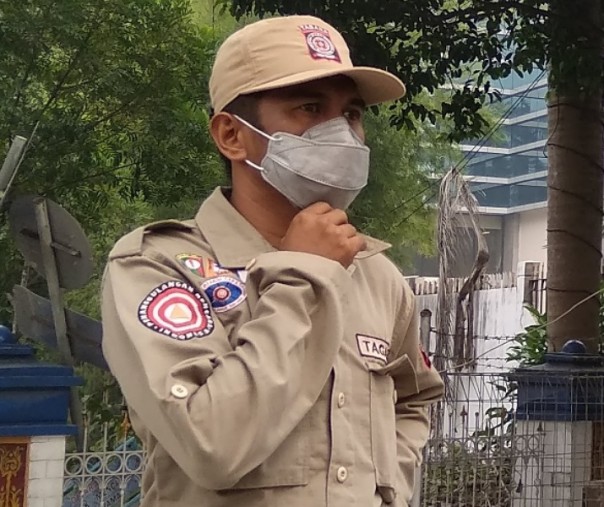 Seorang petugas mengenakan masker saat kabut asap melanda Pekanbaru tahun lalu. Foto: Surya/Riau1.