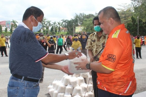 Bupati Inhu H Yopi Arianto SE (kanan) menyerahkan bantuan 2 ton beras kepada Sekdakab Inhu Ir Hendrizal MsI (kiri) usai apel pagi, dihalaman kantor Bupati Inhu, Kamis 9 April 2020
