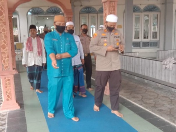 Kapolsek dan Kepala KUA Tualang saat akan salat Jumat berjamaah di Masjid Nurul Islam Kelurahan Perawang