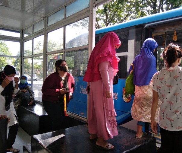 Hanya kaum wanita yang selalu mengenakan masker saat berada di ruang publik, Halte Bus Trans Metro Pekanbaru, Jumat (21/8/2020). Foto: Surya/Riau1.