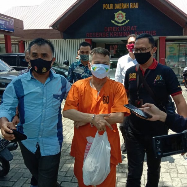 Tersangka M usai menjalani Tahap II di Kantor Ditreskrimsus Polda Riau.