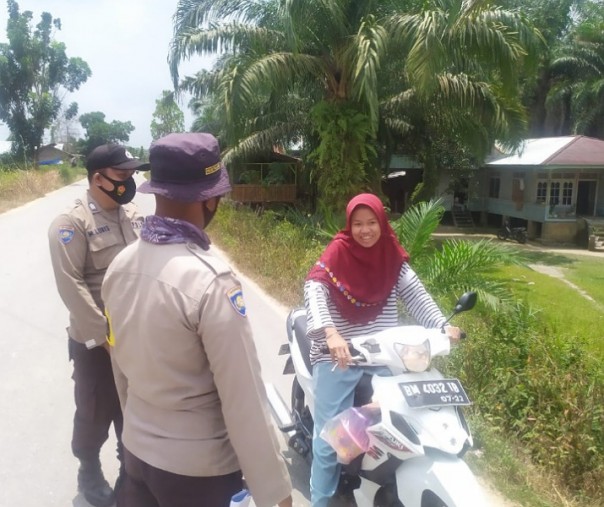 Personel Polsek Langgam saat melakukan serangkaian kegiatan Pemberlakuan Pembatasan Kegiatan Masyarakat, Rabu (24/2/2021). Foto: Istimewa.