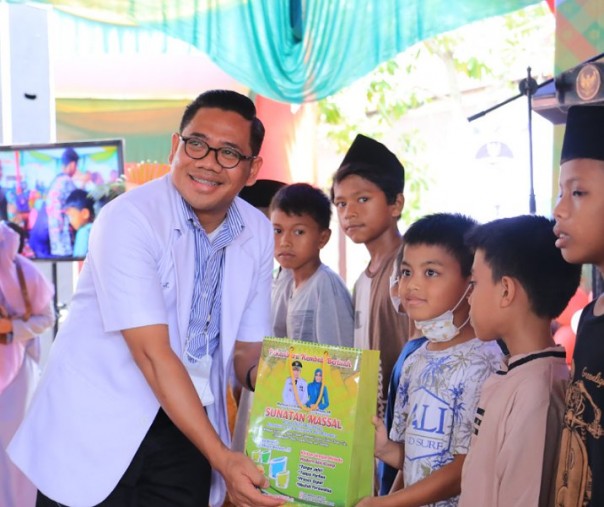 Ketua Khitan Massal Pemko Pekanbaru Dokter Sugeng Riyadi saat memberikan suvenir ke anak-anak yang akan dikhitan di Kantor Kecamatan Bukit Raya pada 12 Agustus 2022. Foto: Istimewa. 